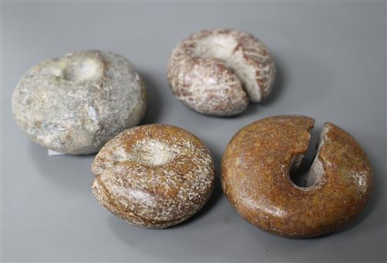 Four Chinese archaistic rings, Huang, possibly neolithic, with natural inclusions to the stone and some calcification to the surface, d
